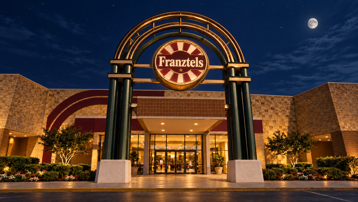 Franztels mall entrance under a dark blue nighttime sky and moon